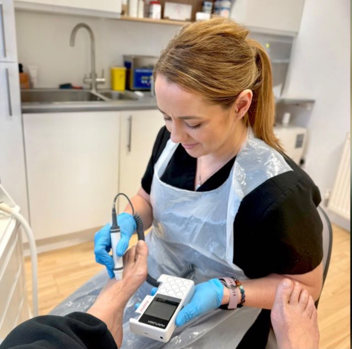 Rachel Rayner providing podiatry care in the clinic